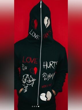 black "Love Hurts" zip-up hoodie is from the streetwear brand Mixed Emotion